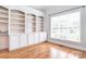 Bright office with hardwood floors, built-in shelving, cabinets, and a large window at 6927 Ellington Farm Ln, Mint Hill, NC 28227