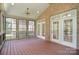 Spacious screened porch with wood flooring, ceiling fan, and access to the outdoors at 6927 Ellington Farm Ln, Mint Hill, NC 28227