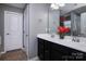 Bathroom with a double sink vanity, tiled floor, and white trim at 7397 Mill Ruins Sw Ave, Concord, NC 28025