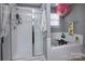 Modern bathroom features a glass-enclosed shower and a relaxing soaking tub at 7397 Mill Ruins Sw Ave, Concord, NC 28025