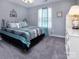 Comfortable bedroom with soft carpeting and natural light from the window at 7397 Mill Ruins Sw Ave, Concord, NC 28025