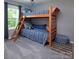 Bedroom with wooden bunk beds and window with gray curtains at 7397 Mill Ruins Sw Ave, Concord, NC 28025