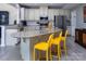 Bright, open kitchen featuring stainless steel appliances, granite countertops, and a large island with bar seating at 7397 Mill Ruins Sw Ave, Concord, NC 28025
