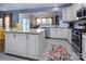 Bright, open kitchen featuring stainless steel appliances, granite countertops, and a large island at 7397 Mill Ruins Sw Ave, Concord, NC 28025