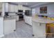 Spacious kitchen with white cabinetry, stainless steel appliances, an island and modern gray floors at 7397 Mill Ruins Sw Ave, Concord, NC 28025