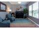 Inviting living room with large windows, piano and comfortable seating area offering a relaxing space at 7397 Mill Ruins Sw Ave, Concord, NC 28025