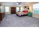 Large main bedroom with a ceiling fan, dresser, and ample sunlight at 7397 Mill Ruins Sw Ave, Concord, NC 28025