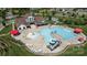 Aerial view of the community pool with lounge chairs, splash pad, and slide at 7397 Mill Ruins Sw Ave, Concord, NC 28025