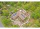 Aerial view of home with solar panels, patio, and landscaped yard surrounded by trees at 78 N Scalybark Trl, Concord, NC 28027