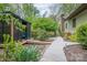 Walkway leading to a screened gazebo surrounded by lush greenery at 78 N Scalybark Trl, Concord, NC 28027