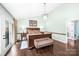 This primary bedroom features a seating bench, hardwood floors and access to an outdoor balcony at 78 N Scalybark Trl, Concord, NC 28027