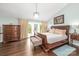 Primary bedroom boasts hardwood floors, stylish furniture, and access to an outdoor balcony at 78 N Scalybark Trl, Concord, NC 28027