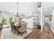 Open-concept dining room featuring hardwood floors, access to a balcony, and stylish furnishings at 78 N Scalybark Trl, Concord, NC 28027