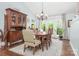 Elegant dining room featuring a wooden table, comfortable seating, and a decorative china cabinet at 78 N Scalybark Trl, Concord, NC 28027