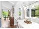 Bright dining room featuring hardwood floors, modern lighting, and access to a deck with views of nature at 78 N Scalybark Trl, Concord, NC 28027