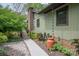 The side of the house features a brick chimney, a charming rain chain, and decorative plants at 78 N Scalybark Trl, Concord, NC 28027