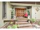 Inviting front entrance with double doors, decorative lanterns, and beautiful plants at 78 N Scalybark Trl, Concord, NC 28027