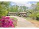Charming single-story home featuring a long driveway and lush landscaping at 78 N Scalybark Trl, Concord, NC 28027