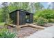 Outdoor gazebo with seating, lighting, and a platform entryway surrounded by greenery at 78 N Scalybark Trl, Concord, NC 28027