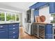 Modern kitchen featuring stainless steel appliances, granite countertop, custom blue cabinets, and hardwood floors at 78 N Scalybark Trl, Concord, NC 28027