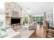 Cozy living room boasts a stone fireplace, hardwood floors, and access to an outdoor living space at 78 N Scalybark Trl, Concord, NC 28027