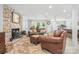 Inviting living room features a stone fireplace, wood stove, and comfortable seating at 78 N Scalybark Trl, Concord, NC 28027