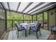 Enclosed sunroom with comfortable seating and natural light at 78 N Scalybark Trl, Concord, NC 28027