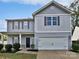 Charming two-story home featuring a front-facing garage and beautifully landscaped yard at 805 Gunnar Dr, Gastonia, NC 28054