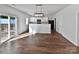 Open-concept living room with wood floors and sliding door access to deck at 805 Gunnar Dr, Gastonia, NC 28054