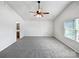 Spacious main bedroom with neutral carpet, ceiling fan, and natural light at 805 Gunnar Dr, Gastonia, NC 28054