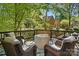 Back deck featuring outdoor seating with wooded backyard view at 902 Hoke Trl, Cramerton, NC 28032