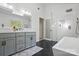 Bright bathroom features black floor tiles, walk-in shower, soaker tub, and a double sink vanity at 902 Hoke Trl, Cramerton, NC 28032