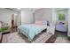 Bedroom with wood flooring, stylish rug, and window for natural light at 902 Hoke Trl, Cramerton, NC 28032