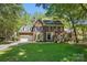 Charming two-story brick home with manicured lawn and mature trees, showcasing classic architectural details at 902 Hoke Trl, Cramerton, NC 28032