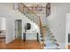 Bright foyer with hardwood floors, elegant staircase, and stylish decor creates a welcoming entrance at 902 Hoke Trl, Cramerton, NC 28032