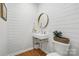 Stylish half bathroom featuring shiplap walls, a modern sink, and a gold mirror at 902 Hoke Trl, Cramerton, NC 28032