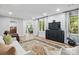 Comfortable living room with decorative rug, recessed lighting, and view to breakfast nook at 902 Hoke Trl, Cramerton, NC 28032