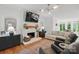Cozy living room with stone fireplace, modern lighting, and comfortable seating offers a relaxing space at 902 Hoke Trl, Cramerton, NC 28032