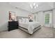 Main bedroom with a king-sized bed, tray ceiling, and ample natural light from the windows at 902 Hoke Trl, Cramerton, NC 28032