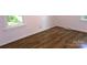Bright bedroom features light walls, trim, and hardwood floors that complement the natural light from the window at 906 N 11Th St, Albemarle, NC 28001