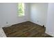 Cozy bedroom with hardwood floors, a window providing natural light, and neutral-colored walls at 906 N 11Th St, Albemarle, NC 28001