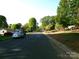Quiet residential street lined with lush trees and well-maintained homes, creating a serene neighborhood atmosphere at 906 N 11Th St, Albemarle, NC 28001