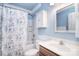 Bathroom featuring a shower/tub combo with a floral curtain and a coordinating vanity and mirror at 9106 Dogwood Ridge Dr, Charlotte, NC 28227