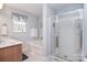Well-lit bathroom with a double vanity, shower with glass door, and a soaking tub at 9106 Dogwood Ridge Dr, Charlotte, NC 28227