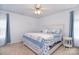 Bedroom featuring neutral walls, carpet flooring, ceiling fan, a bed with blue bedding, and lots of natural light at 9106 Dogwood Ridge Dr, Charlotte, NC 28227
