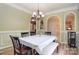 Dining room features elegant lighting, decorative archways, and hardwood floors at 9106 Dogwood Ridge Dr, Charlotte, NC 28227