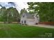 Exterior view with two-car garage, American flag, and well-kept lawn at 9106 Dogwood Ridge Dr, Charlotte, NC 28227