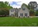Charming two-story home with green shutters, manicured lawn, and beautiful landscaping at 9106 Dogwood Ridge Dr, Charlotte, NC 28227