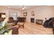 Open concept living room with a fireplace, laminate flooring, and a bar area at 9106 Dogwood Ridge Dr, Charlotte, NC 28227
