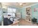 Bright office space with a large window, built-in bookshelf, comfortable chair and functional desk at 9106 Dogwood Ridge Dr, Charlotte, NC 28227